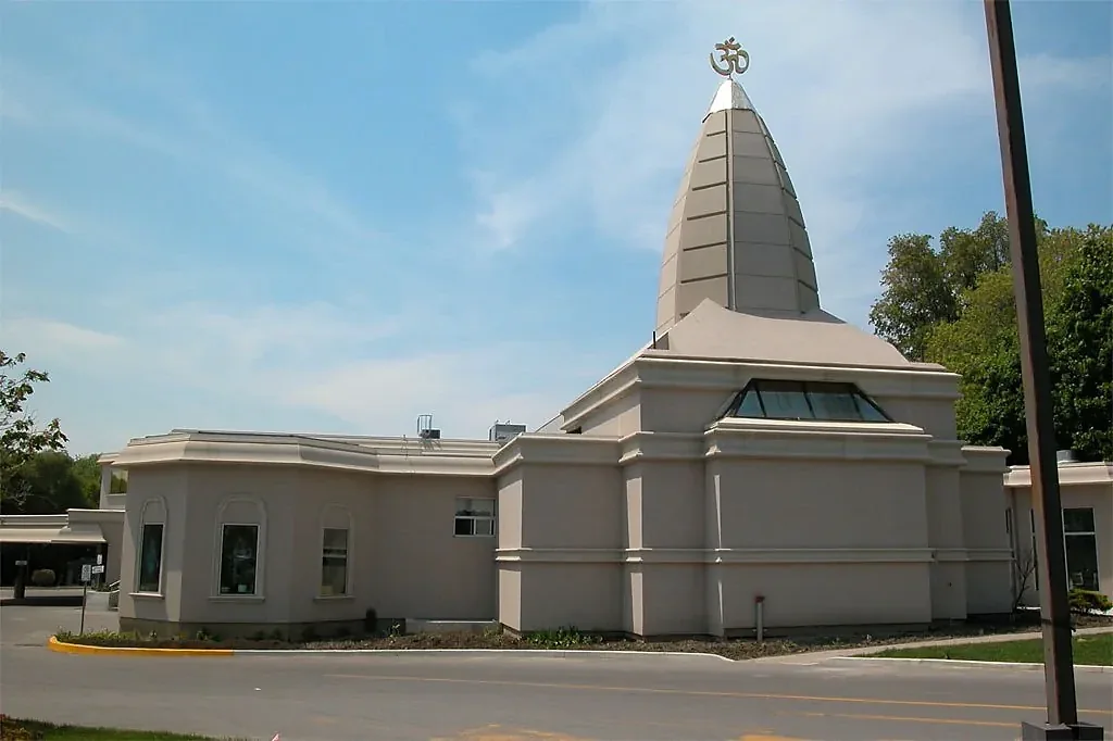 Low building with an ornamental tower and layered roofline trim