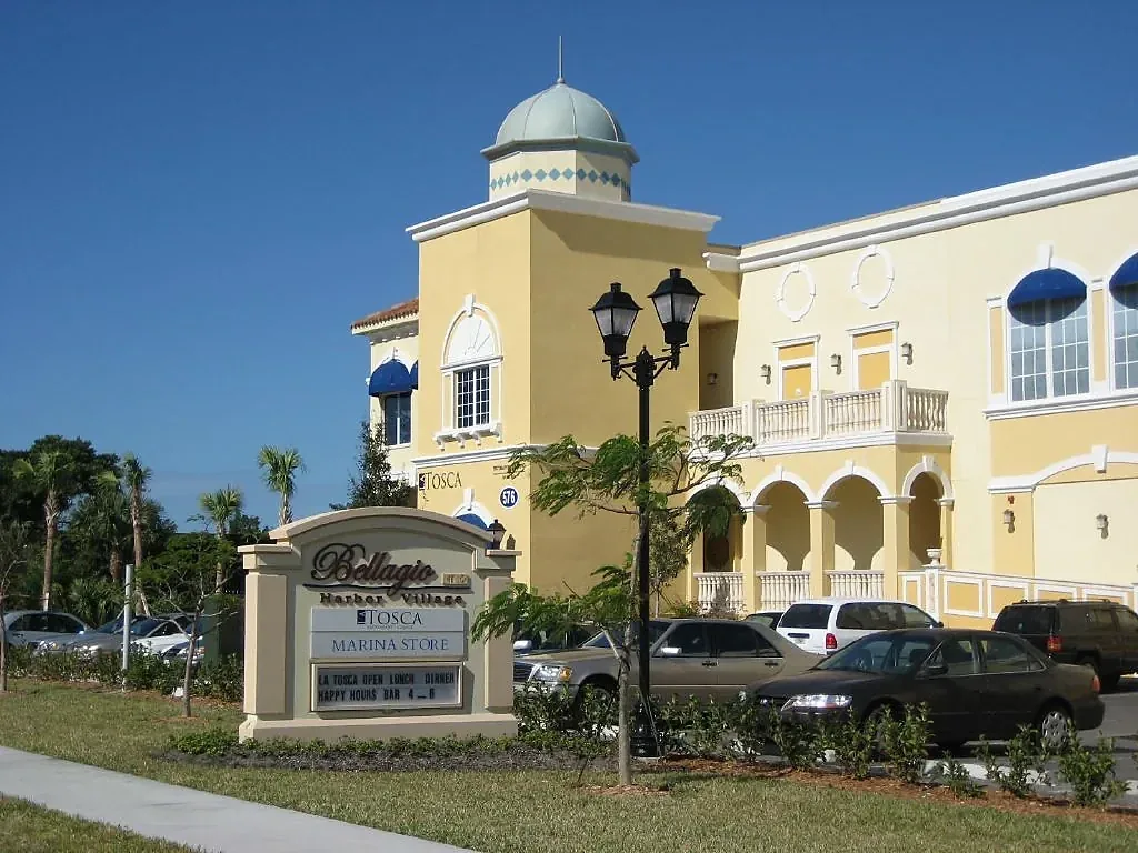 Pale facade with an arcade, decorative parapet and domed corner tower