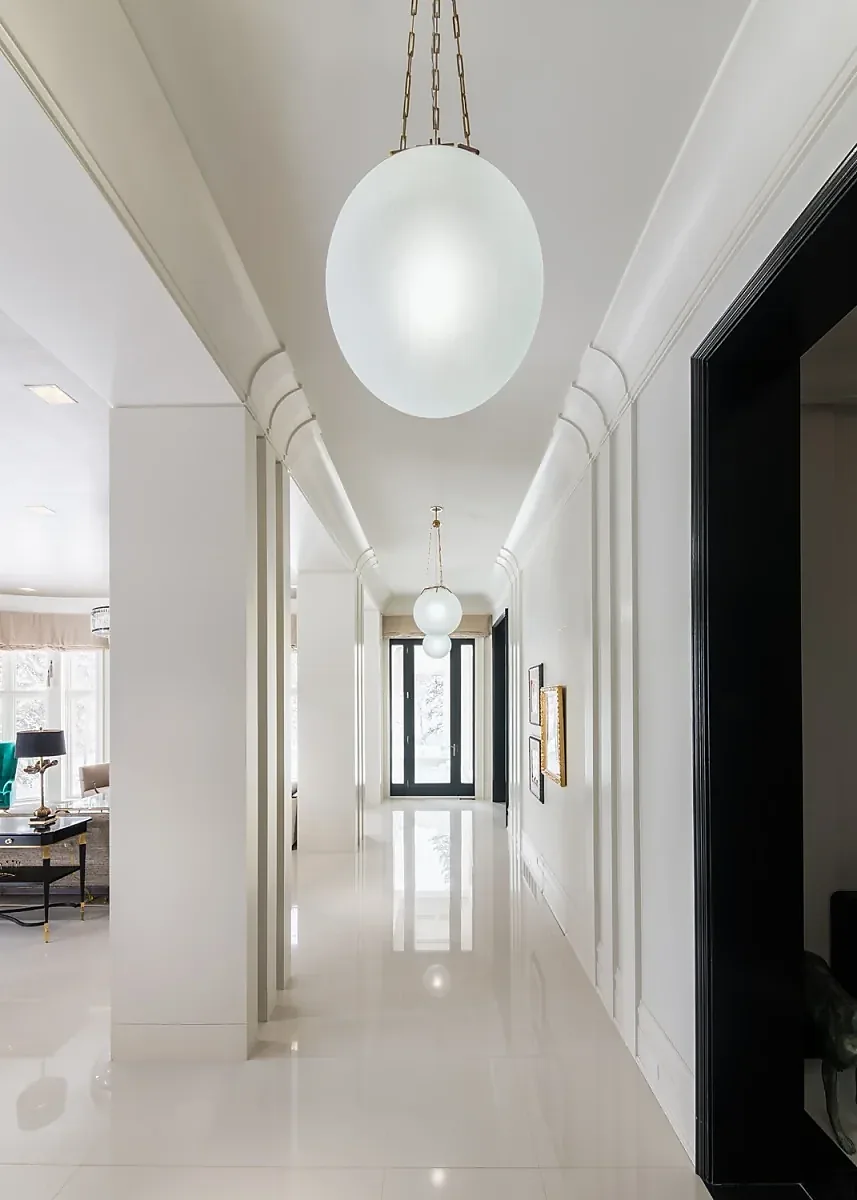 Hallway with layered ceiling moulding and globe pendant lights
