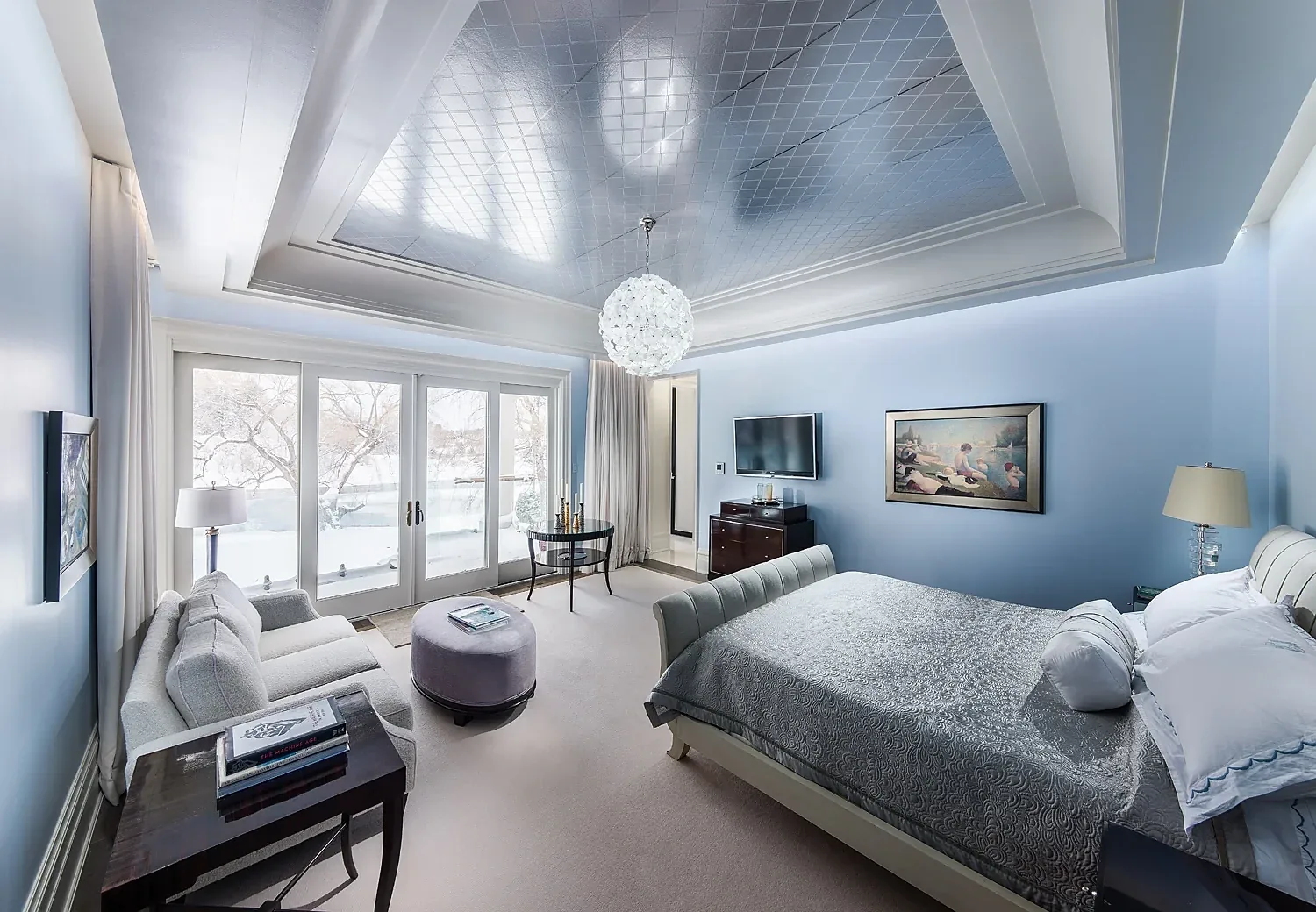 Bedroom with a recessed ceiling and perimeter crown moulding