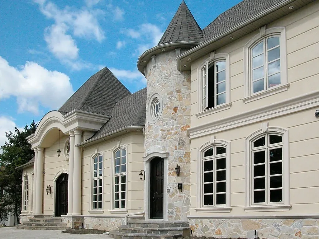 Residence with a rounded bay and coordinated window surrounds