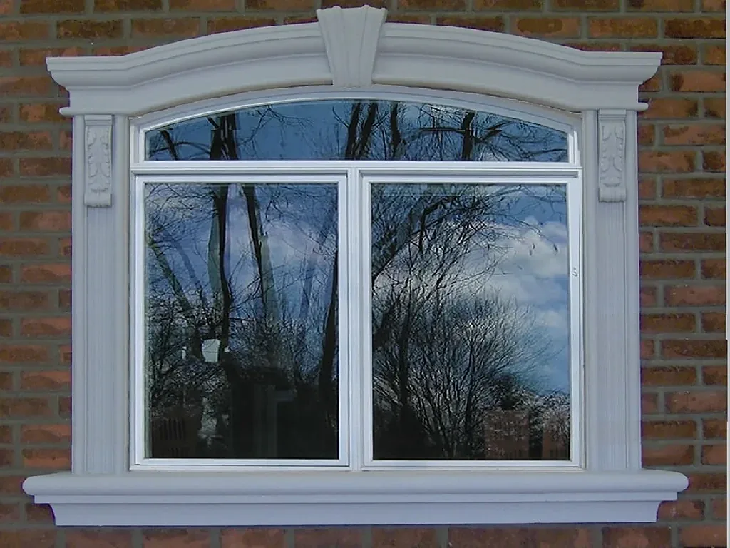Curved window header and sill against a red brick wall