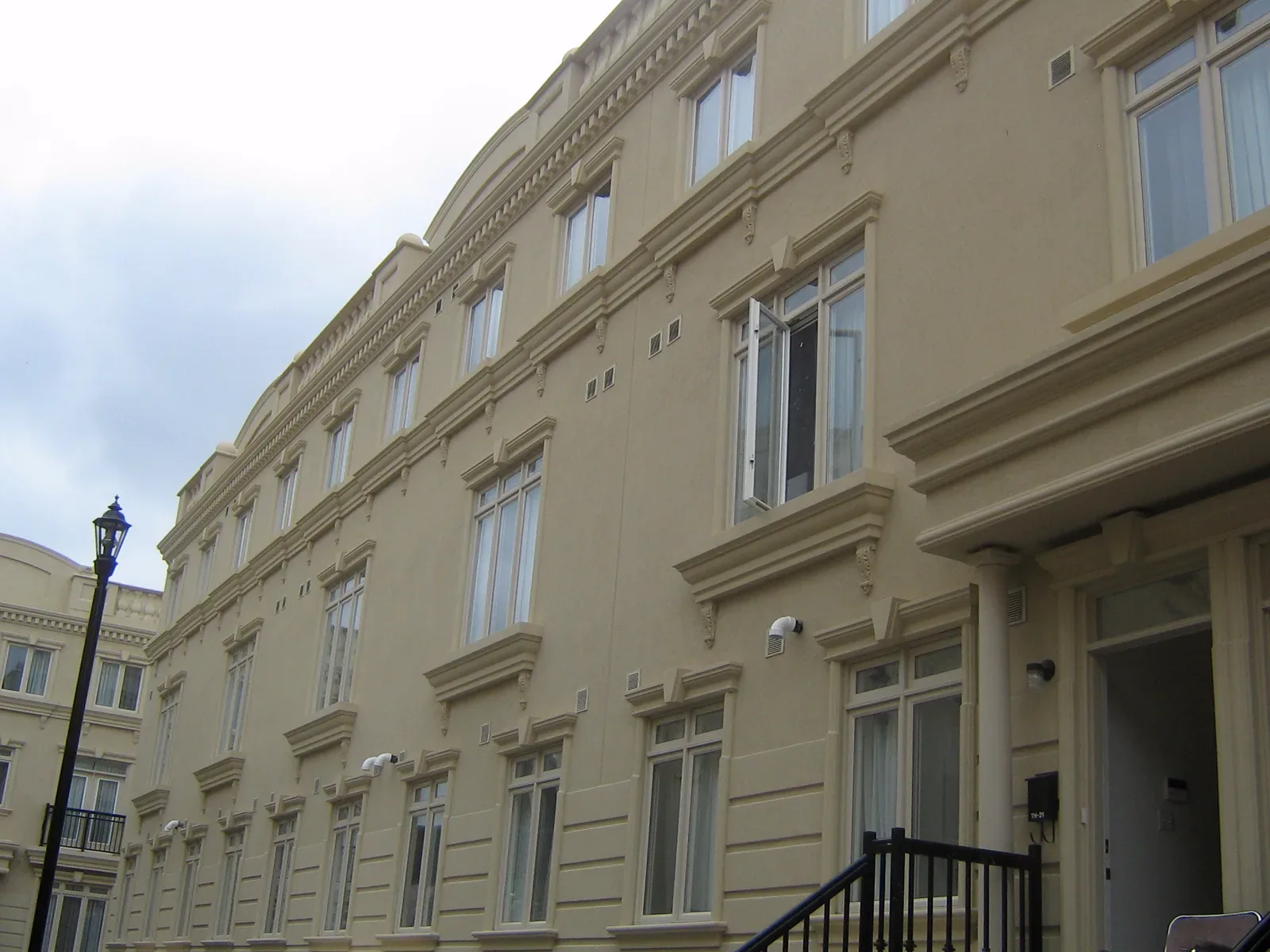 Coordinated exterior profiles across a multi-residence façade