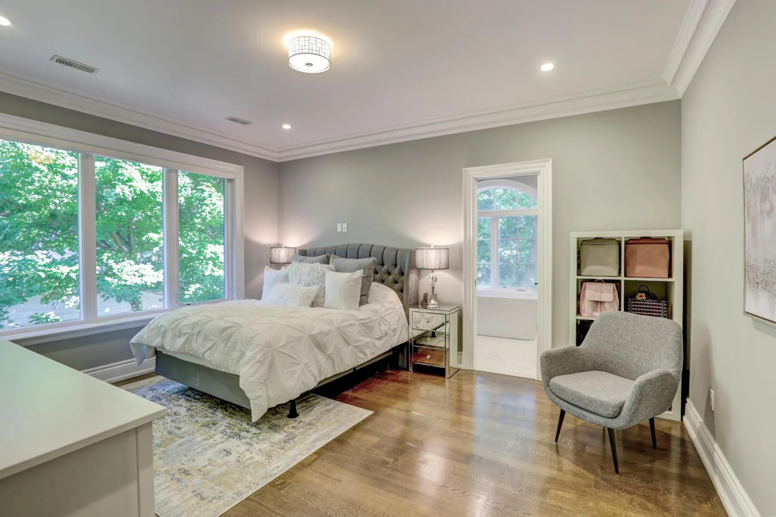 Bedroom with layered crown moulding and recessed ceiling lighting
