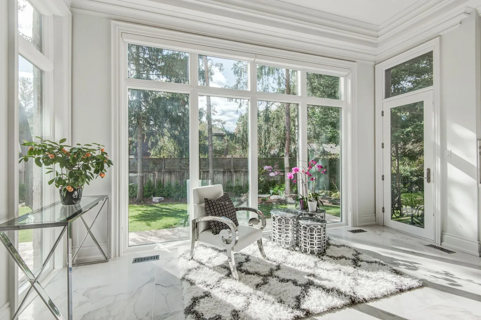 Bright sitting area with tall windows and a layered ceiling perimeter